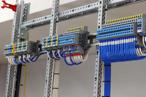 Connecting through-pass electrical terminals in the electrical panel Stock Photos