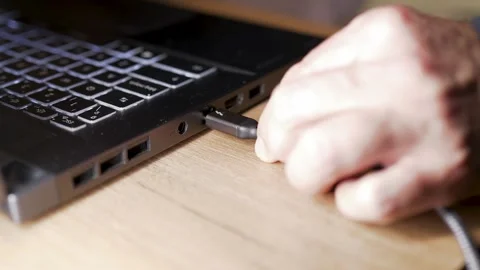 Connecting Thunderbolt Cable to Laptop for Data Transfer. Stock Footage 328072841