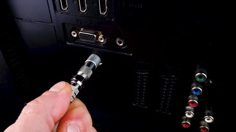 Connecting the TV cable to the TV socket. The man connects the TV, settings Stock Footage 318978514