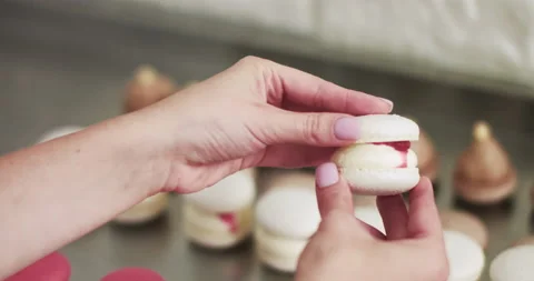Connecting The Two Halves Shells Of Macarons, Decorated With Jam And Ganache Video stock 150400829
