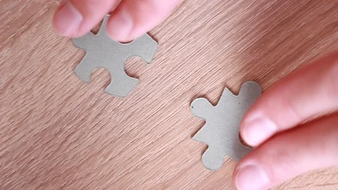 Connecting two pieces of puzzle closeup 스톡 동영상 95318948