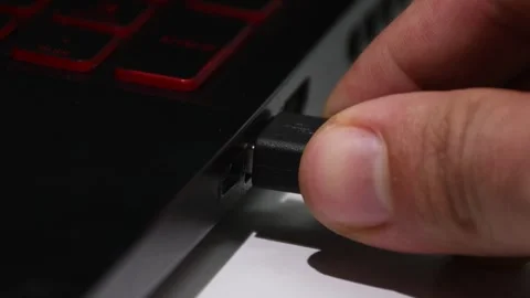 Connecting a USB cable to a computer, hand plugging device into USB port Stock Footage 305779595