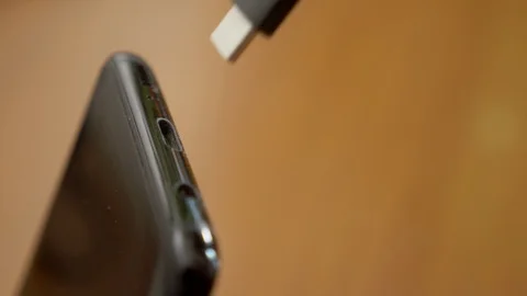 Connecting the USB socket at smartphone. recharging the smartphone- close up 스톡 동영상 96330911