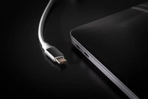 Connecting USB type C cable to laptop computer Stock Photos