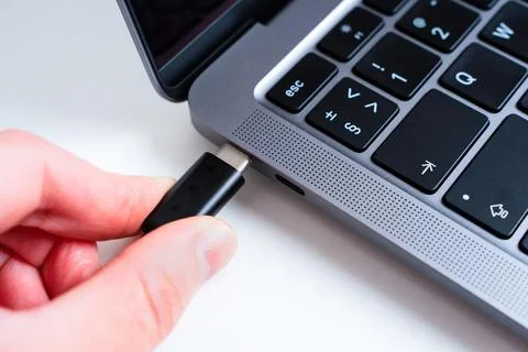 Connecting USB type-C cable to laptop Stock-Fotos