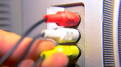 Connecting video and audio cables to the TV Stock Footage 51571730