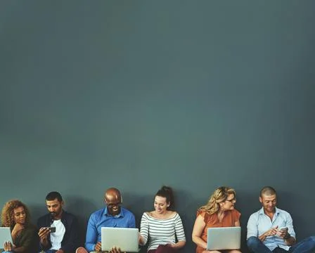 Connecting while we are connected. Studio shot of a diverse group of people s Fotos Stock