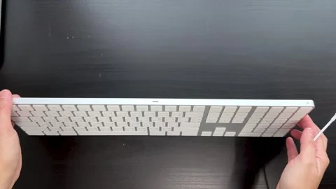 Connecting Wired Numeric Keyboard on Black Desk Top-Down View Stock Footage 318509598