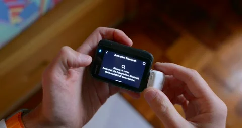 Connecting a Wireless Microphone to an Action Camera via Bluetooth Stock Footage 296629633