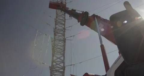 Connecting wires to the high voltage tower Stock Footage 229484370
