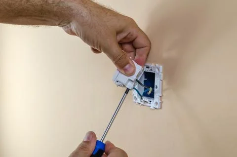 Connecting wires to a light switch Stock Photos