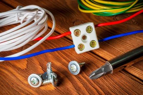 Connecting wires using a plastic clip on a wooden table Stock Photos