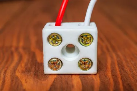 Connecting wires using a plastic clip on a wooden table Stock Photos
