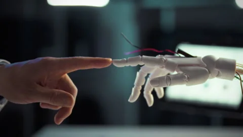 Connection between human and robotic hand in a technological setting promoti Stock Footage 323733173