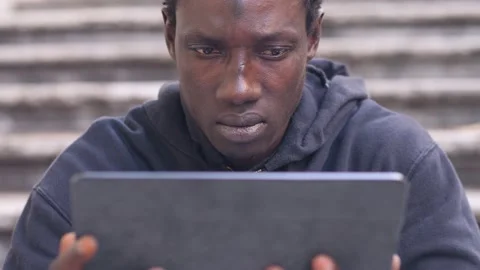 Connection, device - focused black man reads mails on his tablet Stock Footage 231679474