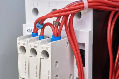 Connection of electrical wires to additional contacts of the magnetic starter Stock Photos