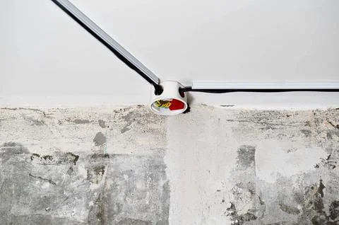Connection of electrical wires in electrical boxes using red caps of connecting Stock Photos