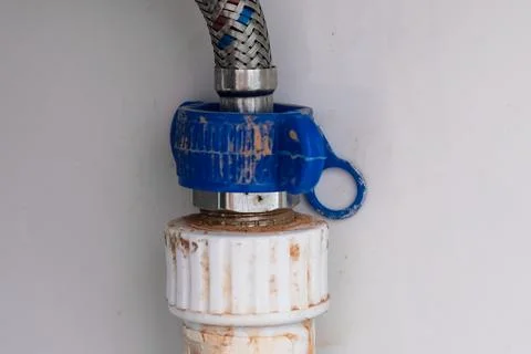 Connection, fitting, adjustment of an old braded flexible water hose to a pol Stock Photos
