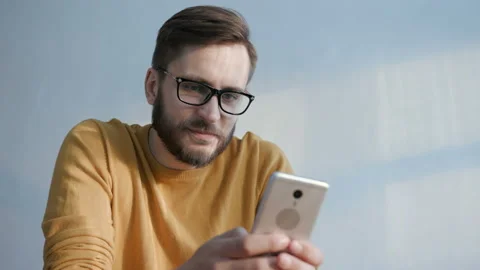 Connection for internet surfing of trendy human with cellphone in social app at Stock Footage 199474783