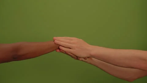 Connection Through Touch Hands Intertwined Together on a Beautiful Green Video stock 293652129