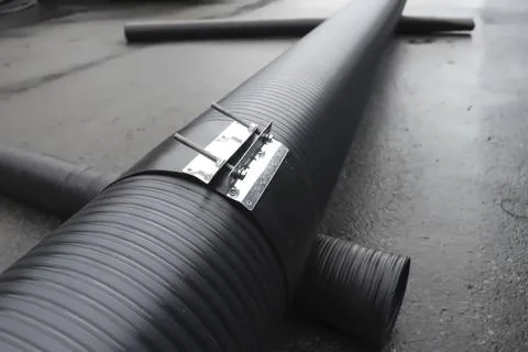 CONNECTION of two ends of polypropylene pipes with clamps. Stock Photos