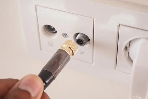 Connector being plugged into wall socket for electrical device Stock Photos