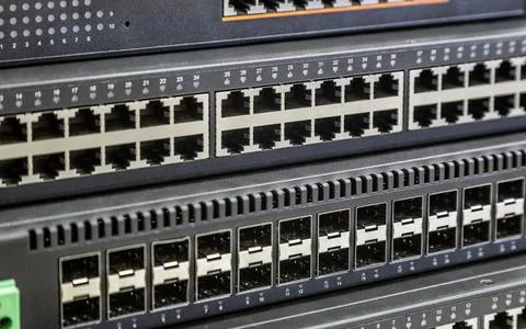 Connectors of a large data center network switch. incoming and outgoing outputs Stock Photos