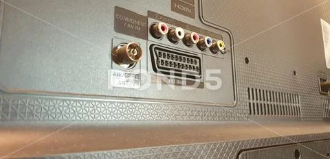 Connects a cable to the TV. Connect the wires to the TV. Stock Photos