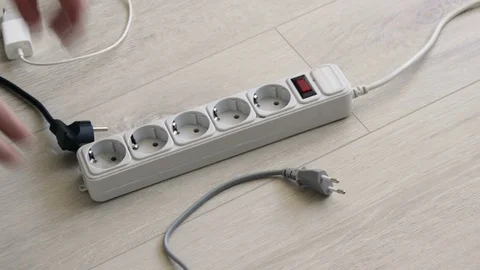 Connects An Electrical Devices. Put the different plug in an extension cord Stock Footage 128229293