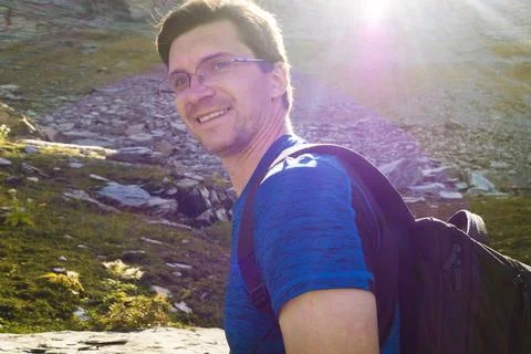 Conquering mountain peaks. A young man makes a trip Stock Photos