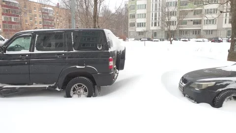 Consequences of snowfall. Streets, courtyards and cars in the snow. Stock Footage 148373057