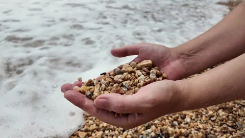 Conservationist Hands Holding Pebbles, Beach Background Stock Footage 274259312
