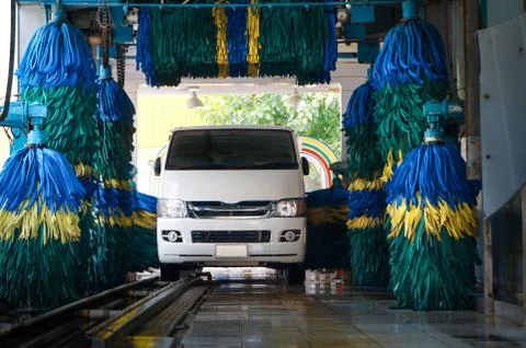 Conservative automatic carwash machine in operation Stock Photos