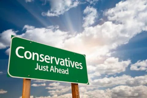 Conservatives Green Road Sign with Dramatic Clouds, Sun Rays and Sky. Stock Photos