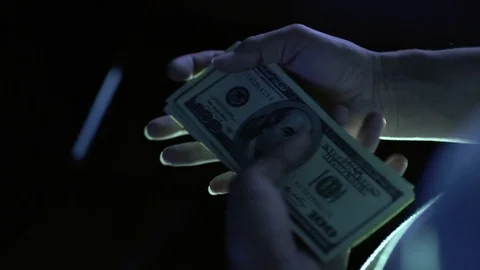 Considers money isolated on black background, against the light 4k Stock-Footage 81741547