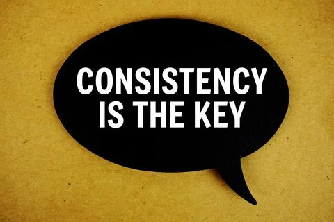 Consistency Is The Key text with speech bubble top view on paper craft back.. Stock Photos