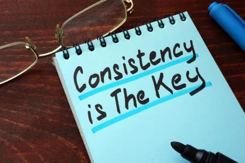 Consistency is The Key written on a notepad with marker. Stock Photos