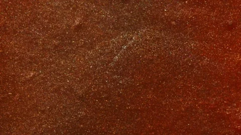 Consistent golden-orange shimmer evenly distributed across the frame in a Vídeo Stock 311665210