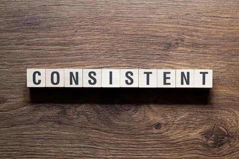 Consistent - word concept on building blocks, text Stock Photos