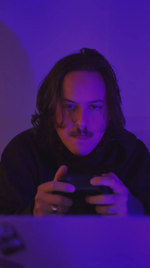 Console Gamer Playing Under Purple RGB Lighting Stock Footage 337968000