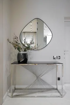 Console table with asymmetrical mirror Fotos Stock