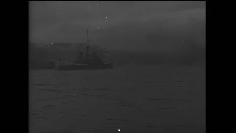 CONSTANTINOPLE - 1910s - Smoke billows from the distant coastline as merchant 動画素材 316680839