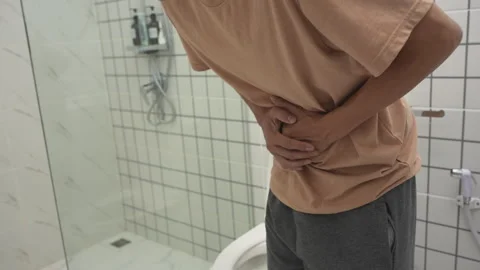 Constipation and diarrhea in bathroom. Hurt man touch belly  stomach ache p.. Stock Footage 336673865