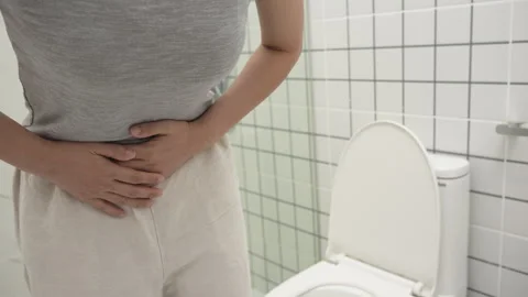 Constipation and diarrhea in bathroom. Hurt woman touch belly  stomach ache.. Stock Footage 337009515
