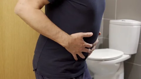 Constipation and diarrhea in bathroom. Hurt man touch belly stomach ache pain Vidéo 337033824