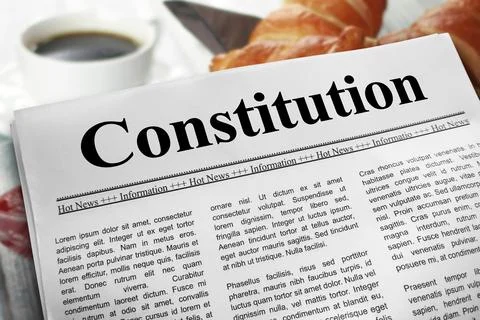 Constitution in newspaper layout on a breakfast table with a blurry cup of .. Stock Photos