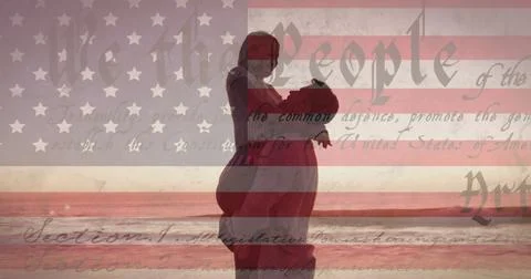 Constitution text over american flag against couple embracing each other at the Fotos Stock