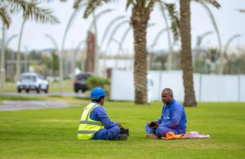 Constraction worker having thier lunch breack at corneach. Doha, Qatar 10-0.. Stock Photos