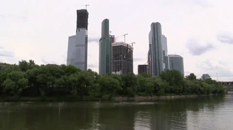 Constructed office skyscrapers on a background of forest park on the river Stock Footage 39667005