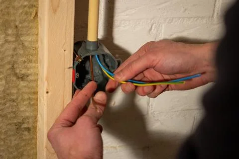Constructing and installing electrical wiring  in a home using cavity wall .. Stock Photos
